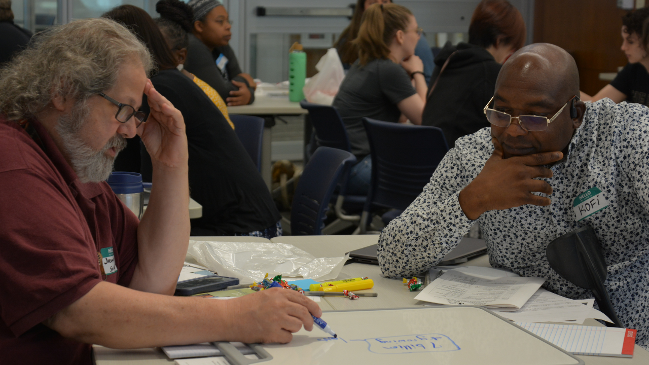 two male teachers sitting at a table